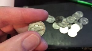 Lots Of Old Nickels. Coin Roll Hunting Nickels Late At Night.