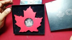 Canadian MAPLE LEAF SHAPE COIN and Australian Thomas Cook commomorative coin from my personal collec