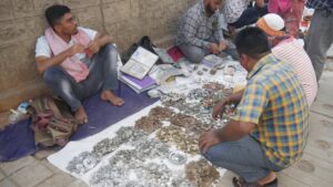 Young and old collector selling their collection in Street in Bangalore